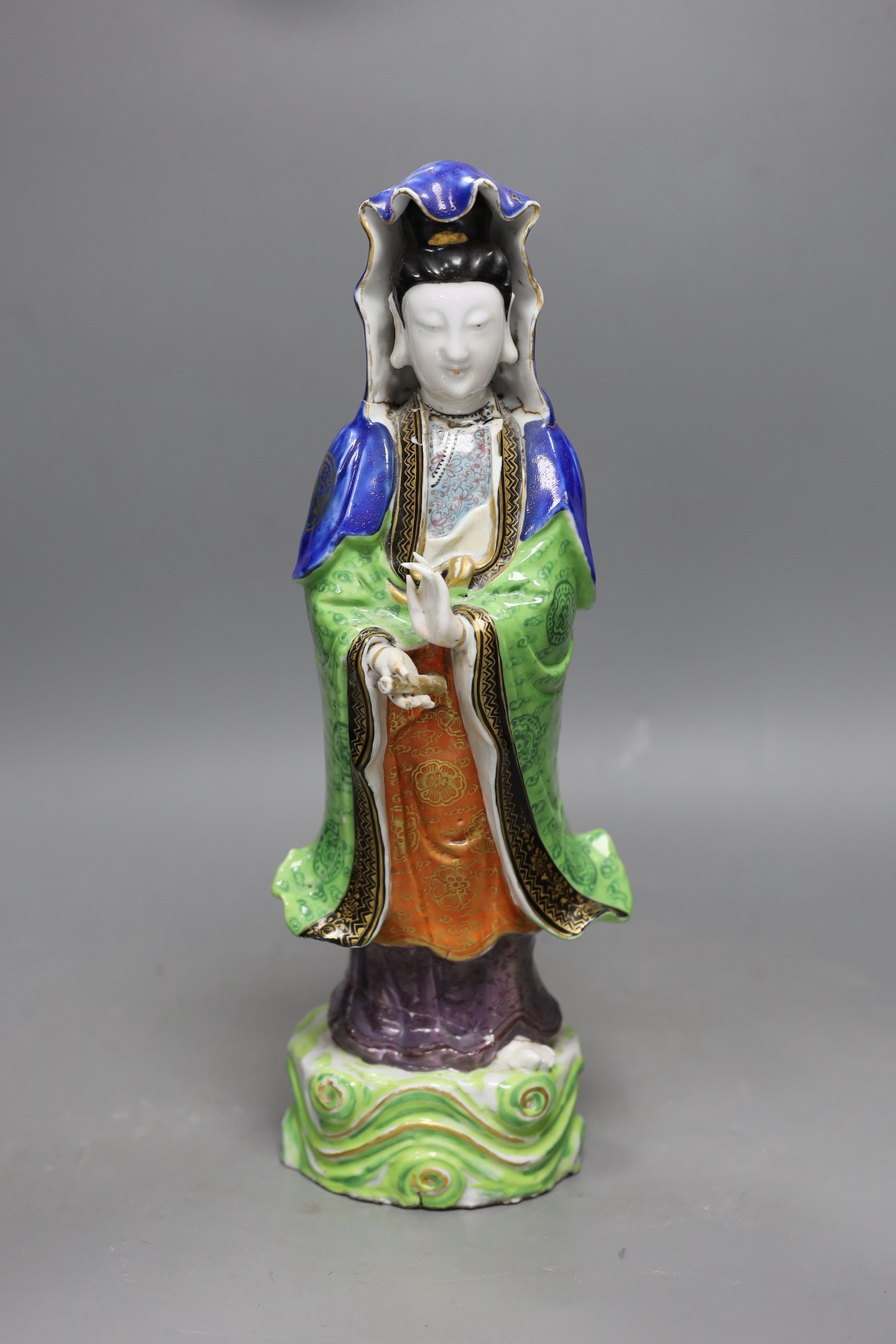 A Chinese enamelled porcelain figure of Guanyin, Jiaqing - Daoguang period, damage, 34cms high